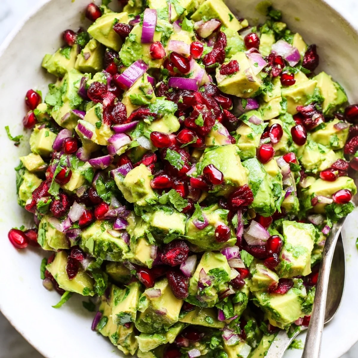 Vibrant cranberry jalapeño avocado salsa served with crispy tortilla chips.  