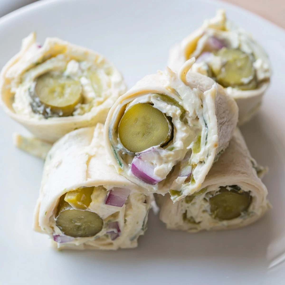 Easy-to-make Pickle-in-a-Blanket featuring creamy cheese and zesty dill pickles.