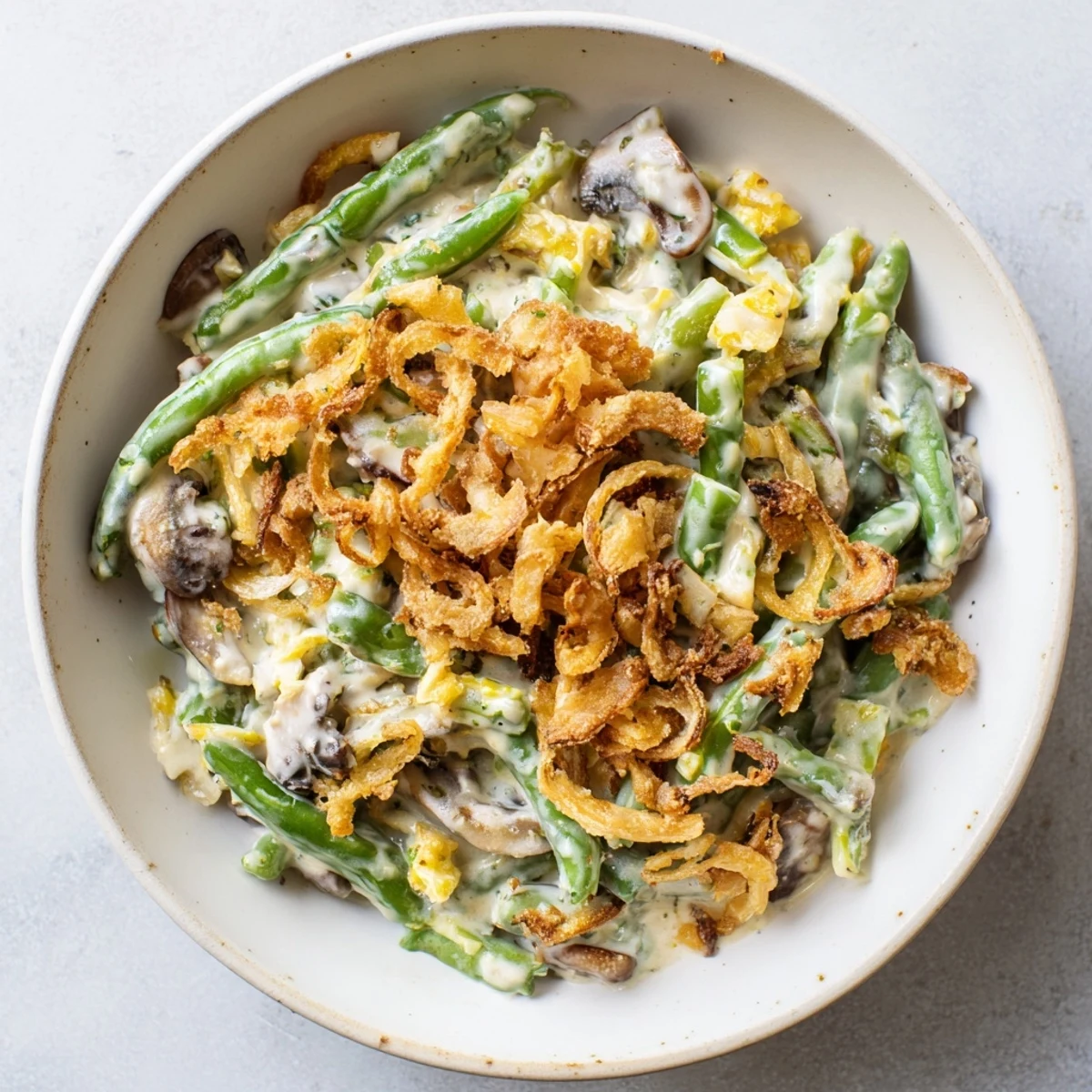 Creamy Old-School Green Bean Casserole topped with crispy fried onions, perfect for holidays.  