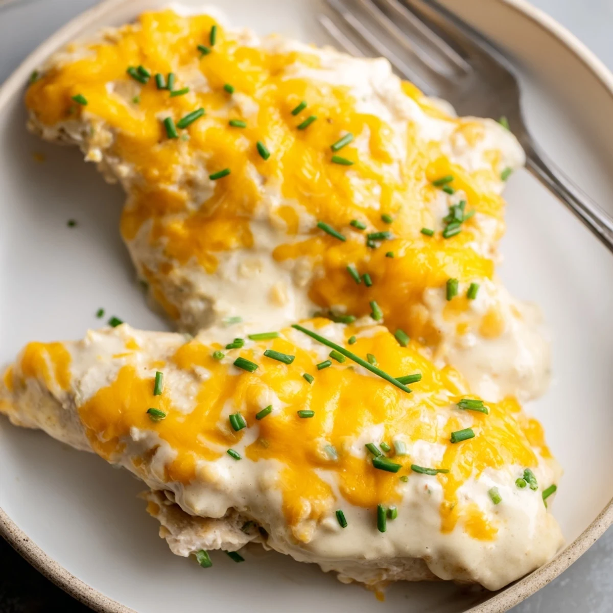 Juicy Cheddar Ranch Chicken Bake topped with golden melted cheese and fresh herbs.  