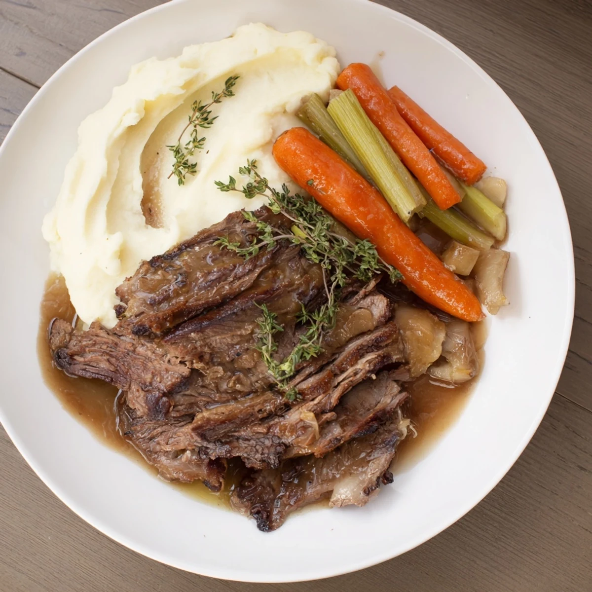 Juicy, slow-cooked beef brisket alongside fluffy, vibrant orange mashed sweet potatoes, ready to eat.