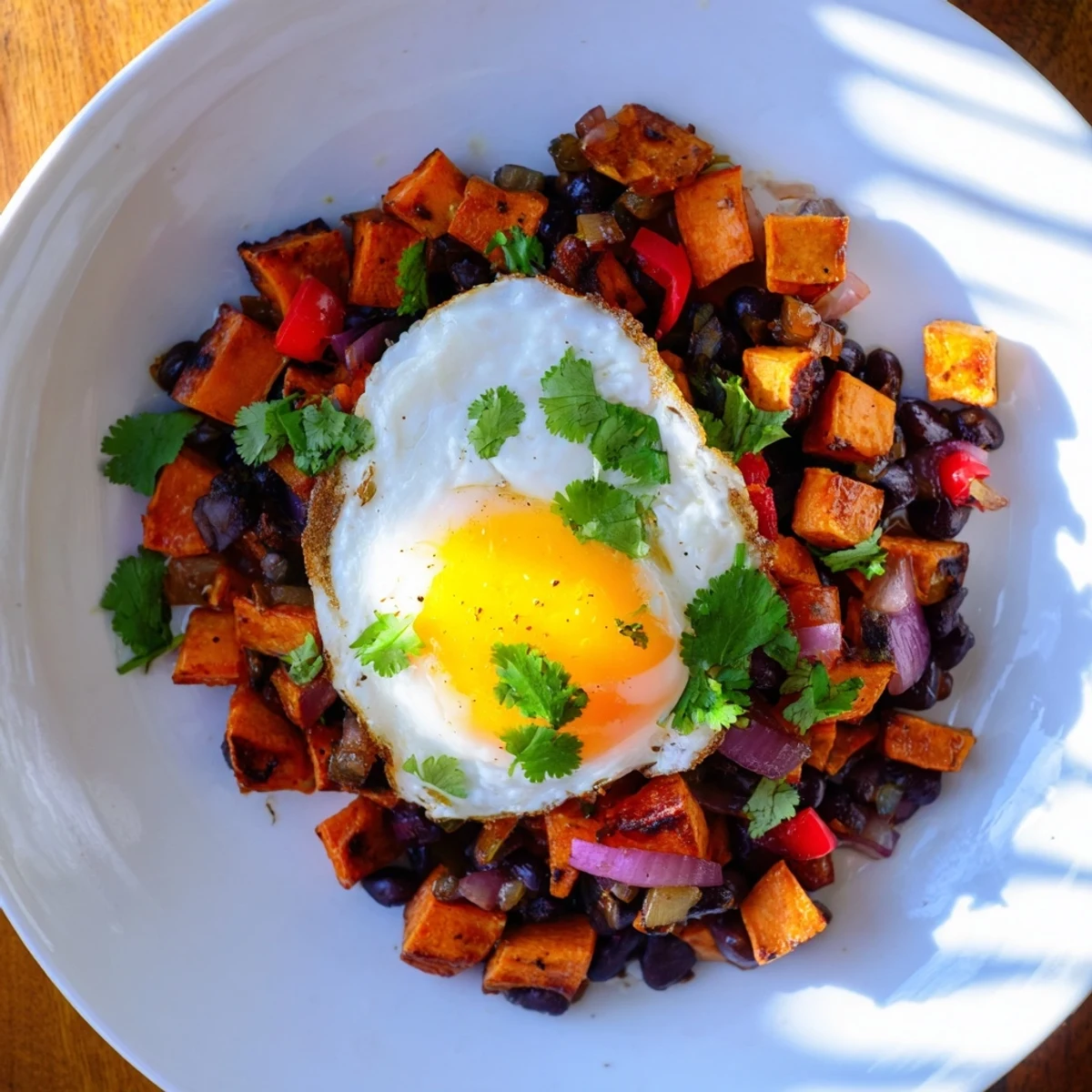 Sizzling skillet of Sweet Potato & Black Bean Breakfast Hash: a colorful, flavorful American breakfast dish.
