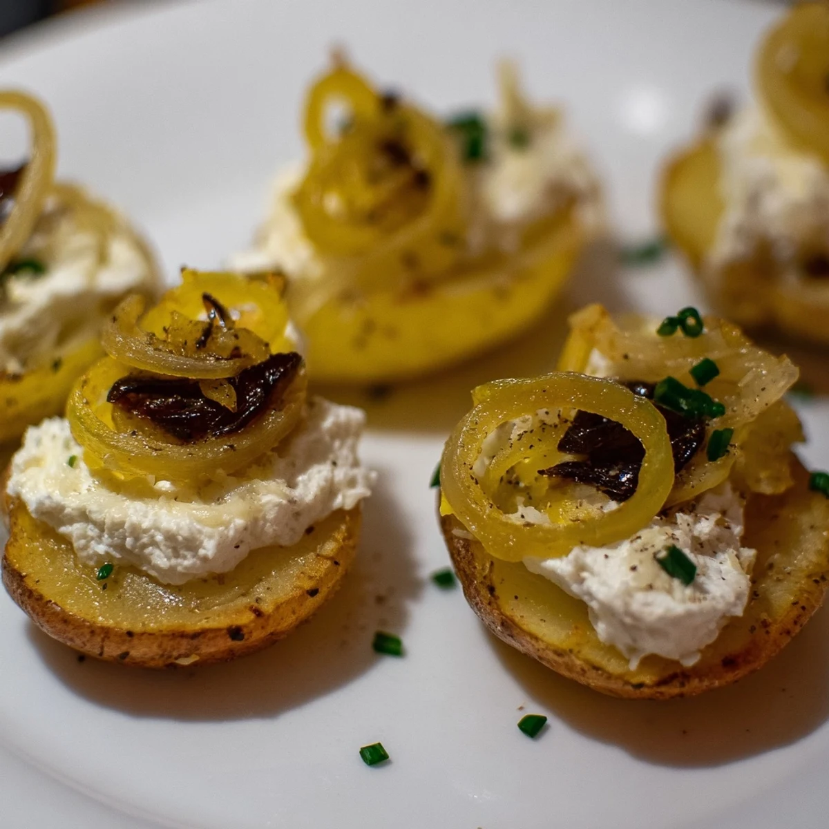 Golden-brown Lightened French Onion Potato Bites, topped with bubbling cheese and caramelized onions for a savory appetizer.