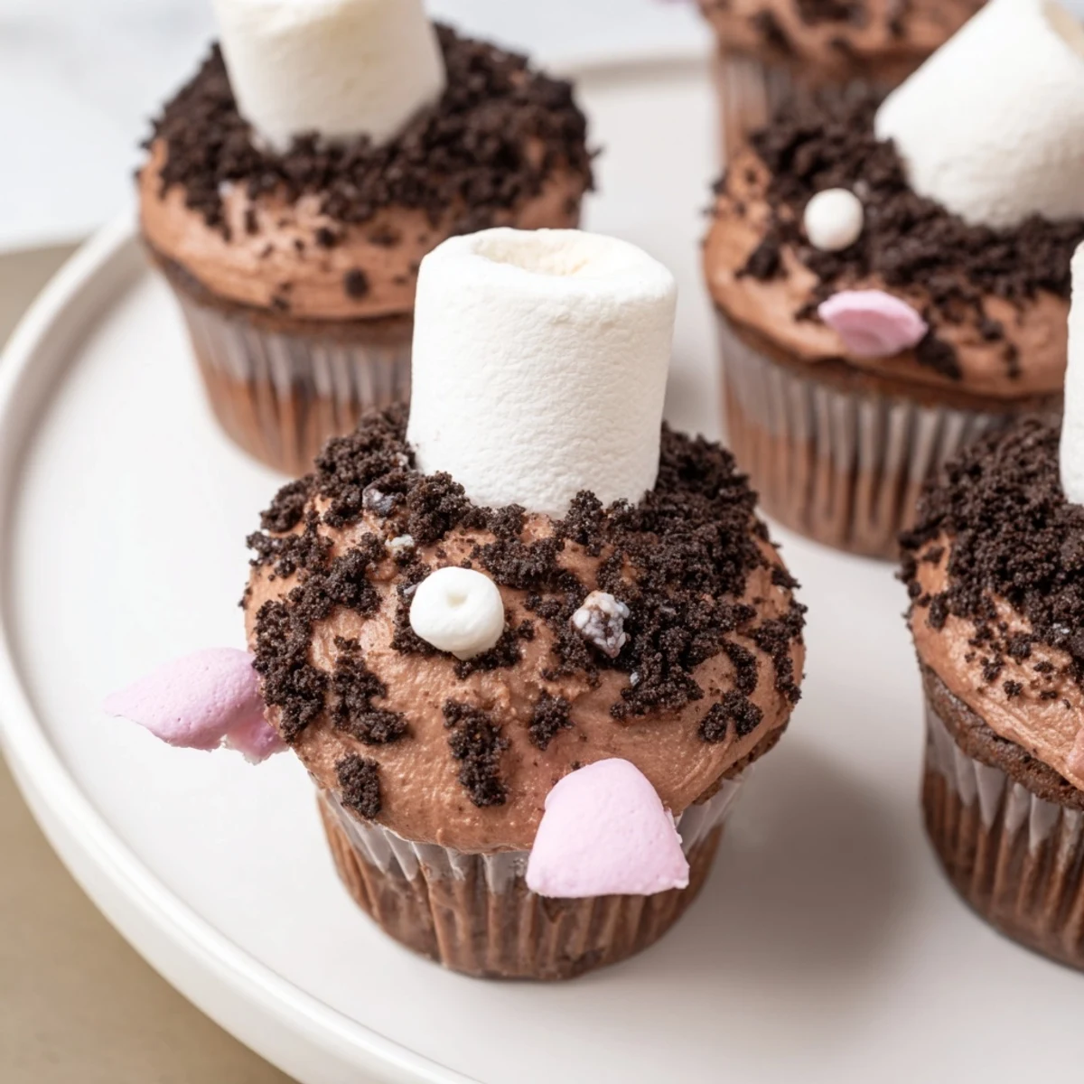 Bunny Burrow Cupcake Tray shows chocolate frosted cupcakes with marshmallow bunnies in cookie "dirt."