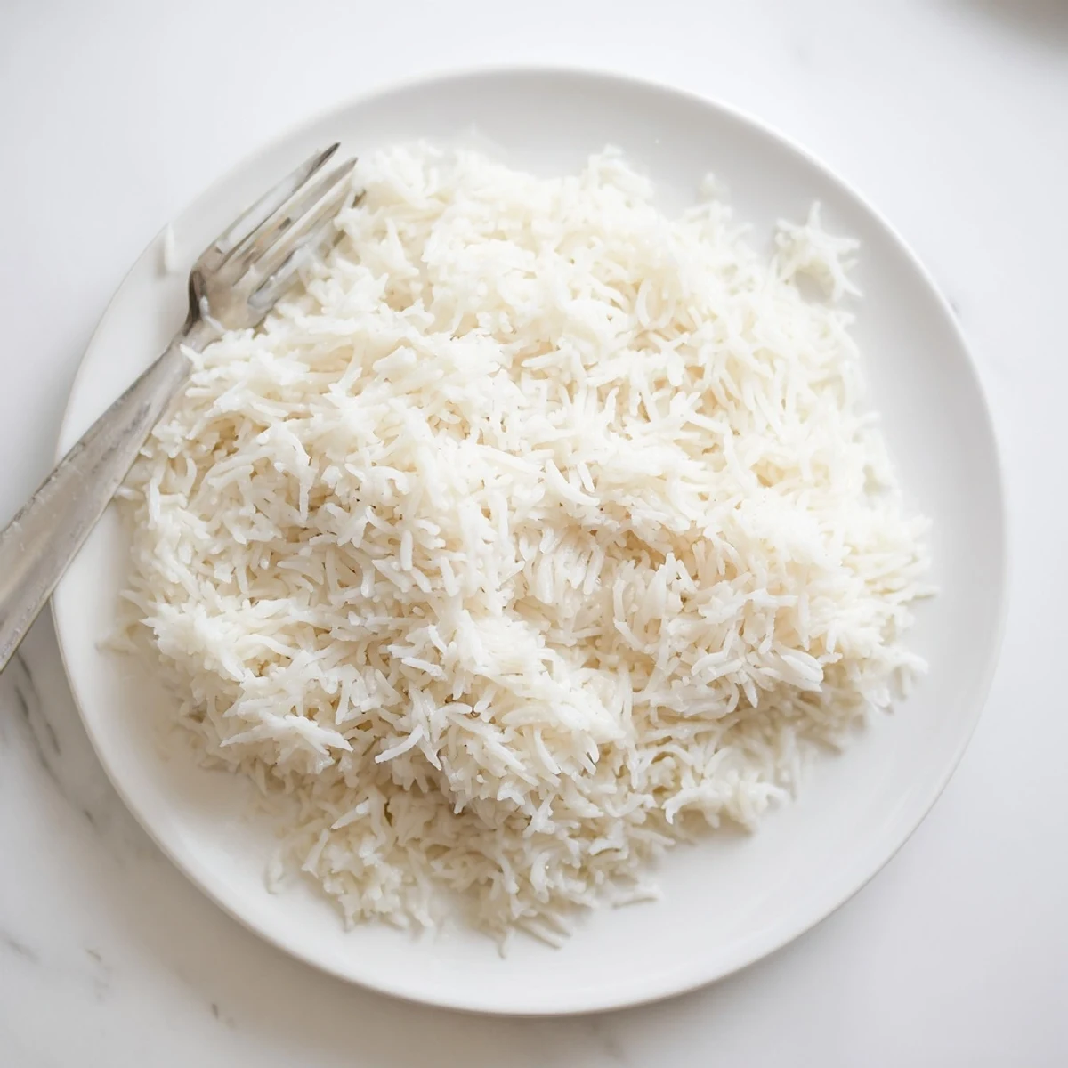 Aromatic Coconut Jasmine Rice, visually described as a light, fluffy texture, ready to serve with grilled chicken.