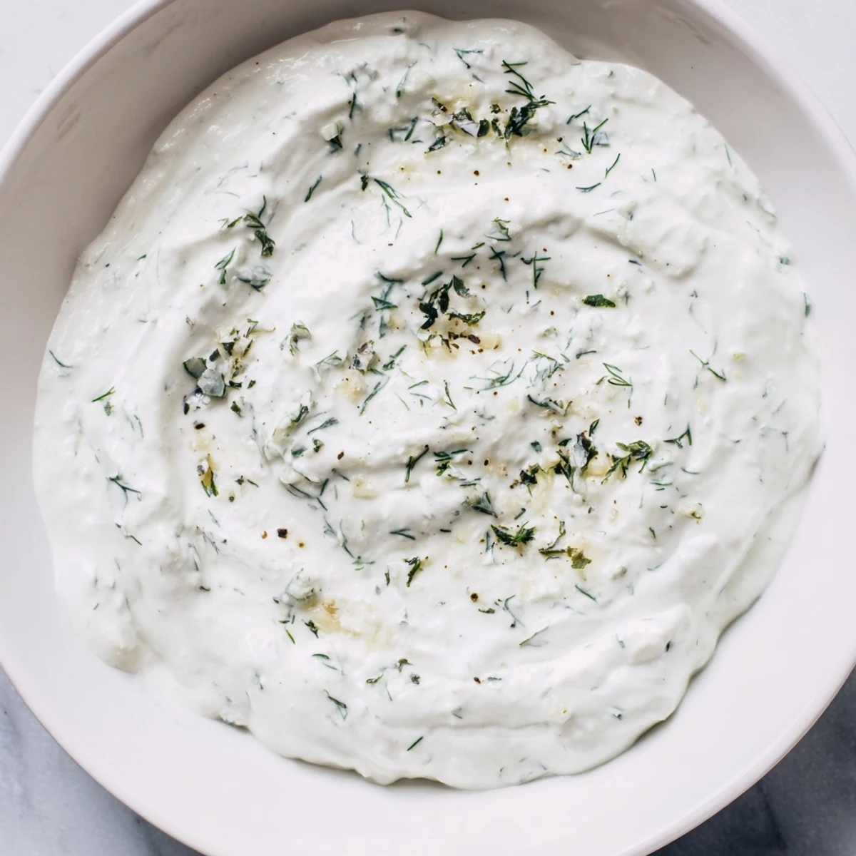 Cool and refreshing, this Greek Yogurt Herb Dip boasts a smooth texture, perfect as a sandwich spread.