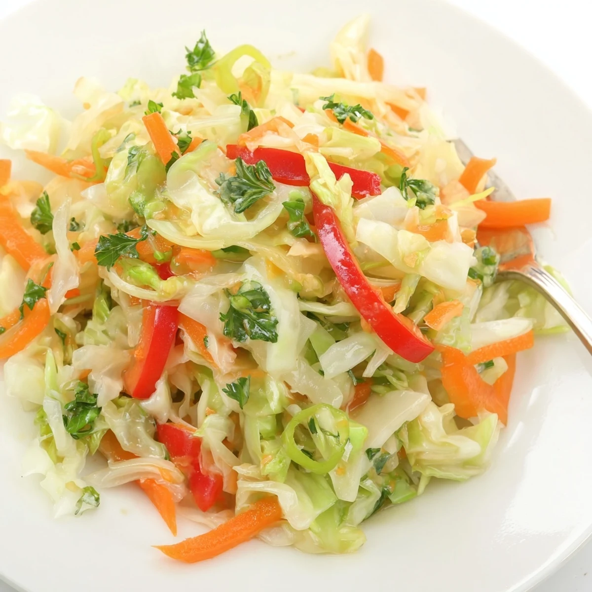 Colorful sauerkraut slaw in a serving bowl, featuring fermented cabbage and crisp veggies tossed in a light, tangy vinaigrette for gut health.