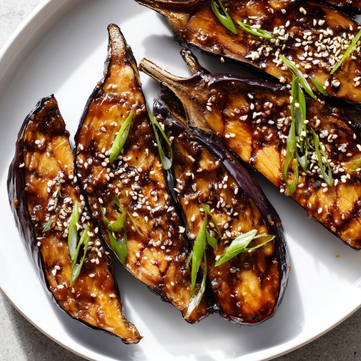 Close-up of Miso Glazed Eggplant with a sticky, broiled topping, ready to be enjoyed as a vegetarian Japanese side dish.