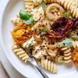 Delicious Baked Feta Pasta topped with fresh basil and a drizzle of olive oil.  