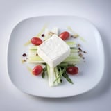 Fresh arugula and colorful vegetables arranged toward the Zenith Point, ready to pair with cheese.