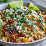 Mexican Street Corn Orzo dish garnished with cilantro and a lime wedge.