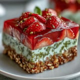 Sweet and salty Pistachio Strawberry Pretzel Jello Salad, a refreshing dessert perfect for summer gatherings.
