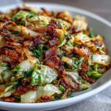 Tender sautéed cabbage, bacon, and onions, perfect alongside any American meal.