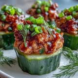 Vibrant, zesty Spicy Tuna Pickle Cups appetizer ready to be devoured.