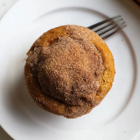 Warmly spiced gingerbread pumpkin muffin donuts topped with cinnamon sugar, perfect for fall.