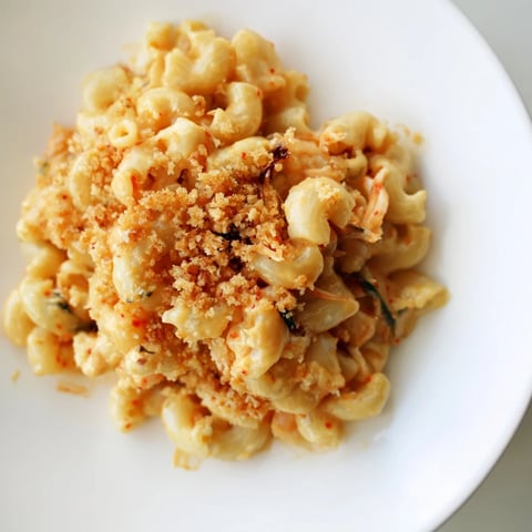 Creamy Spicy Kimchi Mac & Cheese topped with crunchy sesame for a flavorful kick.  