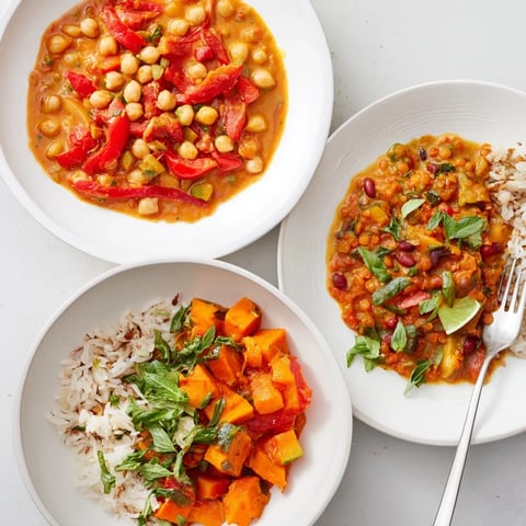 Vibrant Indian Chickpea Curry simmering in a skillet with fresh cilantro garnish.  
