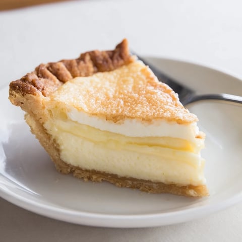 Creamy water pie cooling on a kitchen counter, topped with a golden crust.  