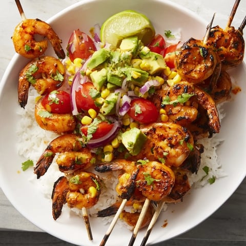 Grilled shrimp bowls filled with colorful salsa, fresh lime, and seasoned shrimp for a light meal.