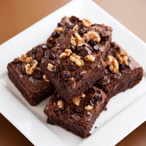 Fudgy sweet potato brownies, featuring a rich chocolate glaze and scattered chocolate chips, ready to enjoy.