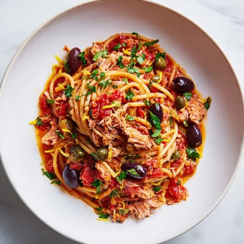 Pasta with Tuna, Olives & Capers: a close-up of a flavorful, Mediterranean pasta dish, ready to serve.