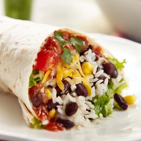 Warm and flavorful rice and bean burritos, with visible layers of beans, rice, and salsa.