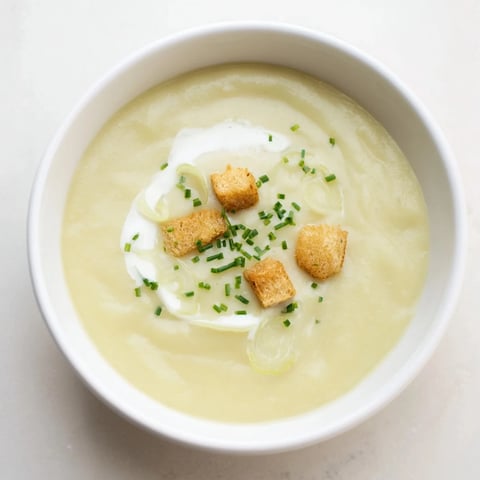 Creamy Potato Leek Soup garnished with fresh chives, a comforting vegetarian soup for cozy nights.