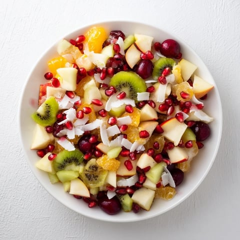 Snowflake Fruit Medley glistens with vibrant fruits, tossed in a citrus dressing, and topped with coconut.