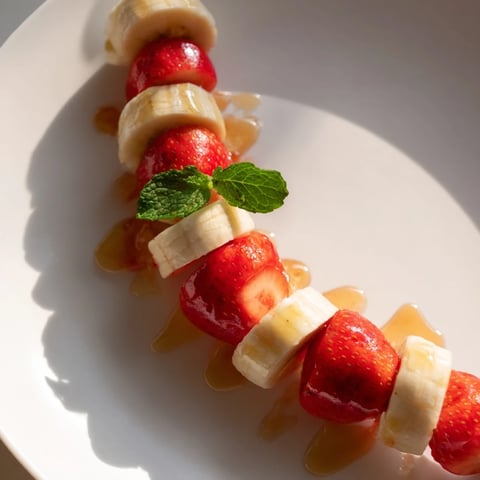 Vibrant banana strawberry candy cane snack, beautifully arranged and ready to enjoy for a healthy treat.