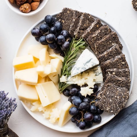 Crescent Moon & Stars Cheese Board: A beautifully arranged cheese board with star-shaped gouda and delicious dark crackers.
