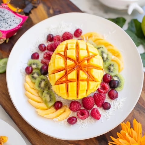 Vibrant Tropical Pineapple Paradise fruit platter ready to eat, with colorful slices and fresh mint.