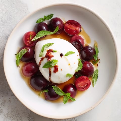 Moonlit Lagoon salad: Juicy blueberries and grapes circle creamy burrata, a perfect summer appetizer.