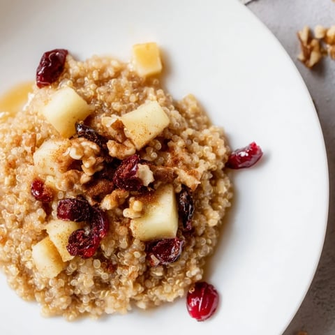 Steaming Apple Cinnamon Quinoa Bowl, a cozy breakfast with tender apples and warming spices for a perfect start.