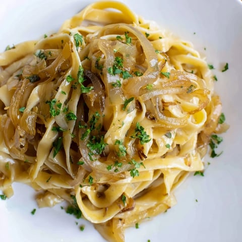Golden brown caramelized onions and melted Gruyère atop One-Pot French Onion Pasta, a hearty main dish.