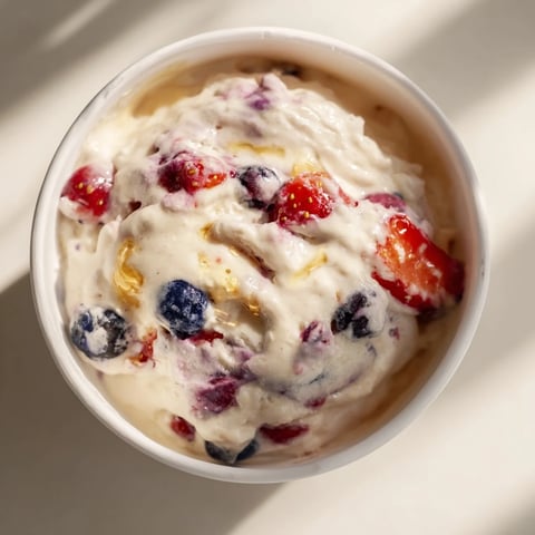 Thick and creamy cottage cheese ice cream with visible berries, a perfect summer dessert.