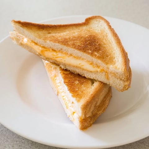 Perfectly golden Mayo Grilled Cheese, with melted cheese oozing from the crusty, mayo-toasted bread.