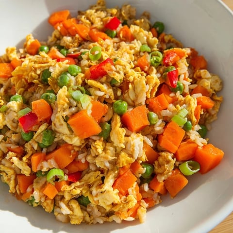 Fluffy Egg Fried Rice, a quick vegetarian meal with colorful veggies and savory soy sauce.