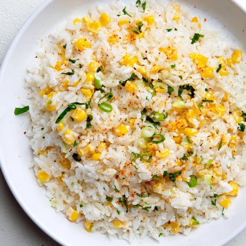 Fluffy Mexican Street Corn Rice, loaded with kernels, cotija cheese, and cilantro, ready to serve.