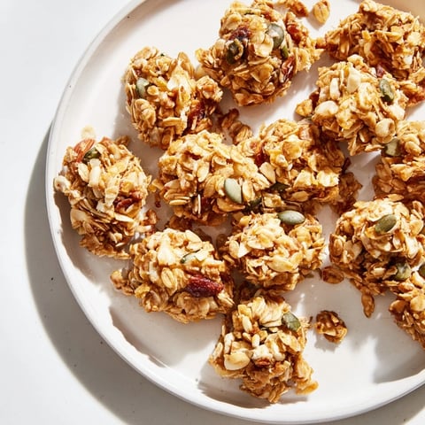 Golden brown homemade granola clusters with oats and nuts, perfect for breakfast or snacking.