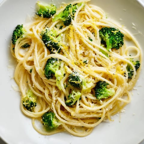 One-pot lemon broccoli pasta steams in a single pot, featuring bright lemon zest and tender broccoli florets in a silky sauce.  