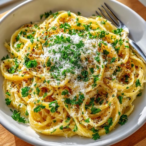 Freshly cooked garlic butter Parmesan noodles served in a bowl, ready for a comforting dinner.