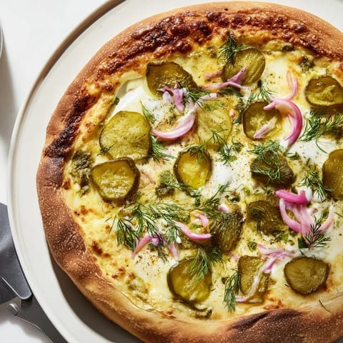Delicious pickle pizza, featuring rich crème fraîche and fresh dill for unique taste.  