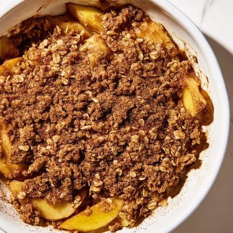 Warm, cinnamon-spiced Apple Crisp, a comforting dessert made with frozen apples and oats.