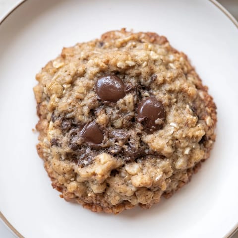 Warm Oat-Banana Chocolate Chip Cookies feature visible chocolate chips and a slightly crisp edge, delicious!