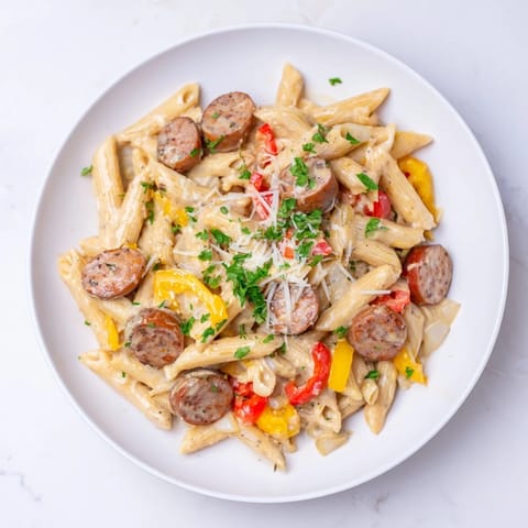 This photo features a close-up of the flavorful Cajun Spiced Smoked Sausage Alfredo, a one-pot meal.