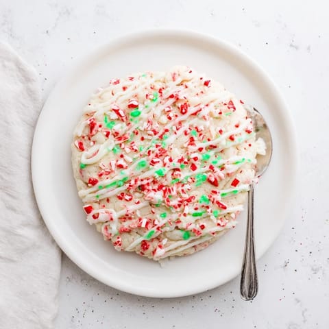 A close-up shot of soft White Chocolate Peppermint Bark Cookies, sprinkled with festive peppermint crumbs.