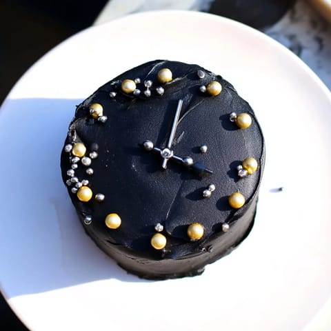 Close-up of baked Countdown Clock Mini Desserts: frosted mini cupcakes decorated like New Year's Eve clock faces.