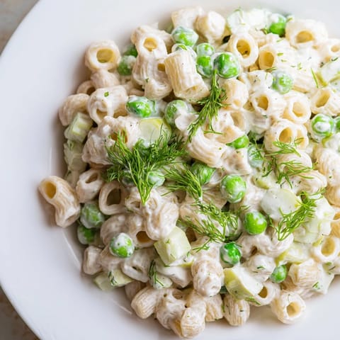Chilled Creamy Dill Pickle Pasta Salad featuring crunchy celery, red onion, and fresh dill in a tangy, creamy mayonnaise-based dressing.