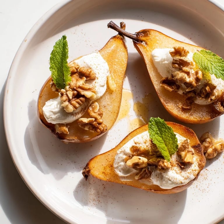 Juicy roasted Roasted Pears glistening with honey, topped with crunchy walnuts and Greek yogurt.