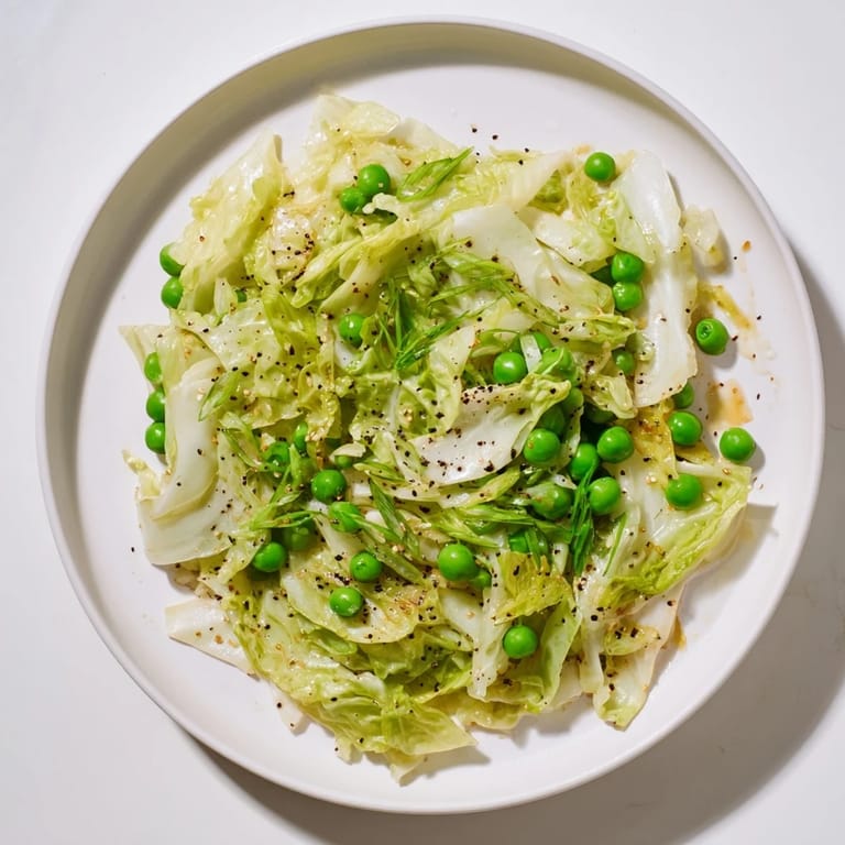 This savory cabbage stir-fry features vibrant green peas and a delicious garlic-soy glaze.